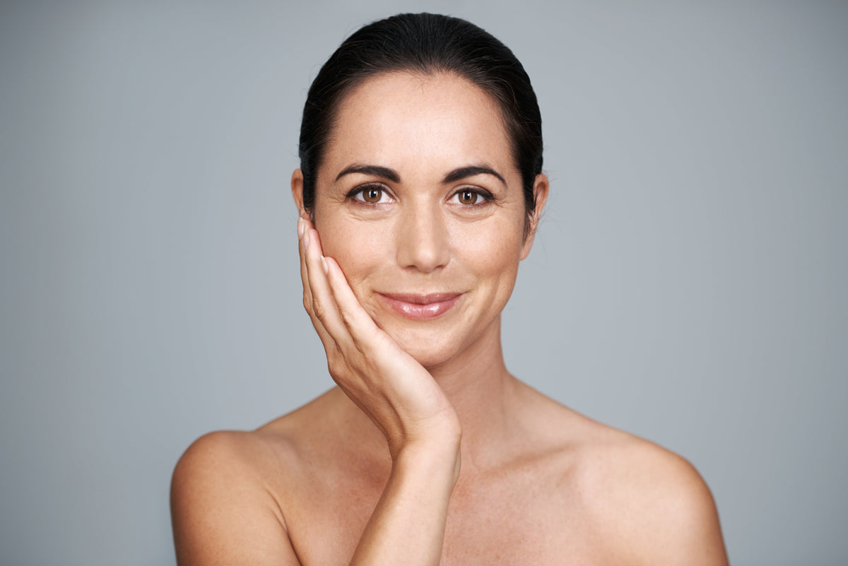 Woman's face with magnified close-ups showing fine lines and wrinkles around the eyes and cheeks
